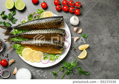 Flat lay composition with tasty smoked fish on grey table 89235036