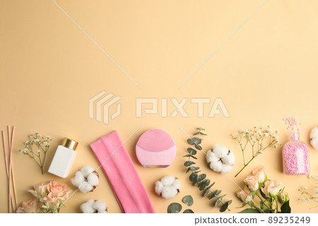 Flat lay composition with face cleansing brush on beige background. Cosmetic accessory 89235249