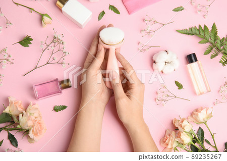Woman with face cleansing brush on pink background, top view. Cosmetic accessory Woman with face cleansing brush on pink background, top view. Cosmetic accessory 89235267