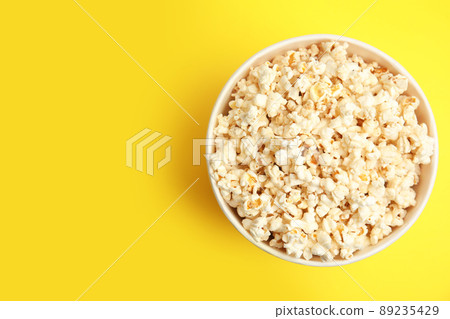 Tasty pop corn on yellow background, top view. Space for text Tasty pop corn on yellow background, top view. Space for text 89235429