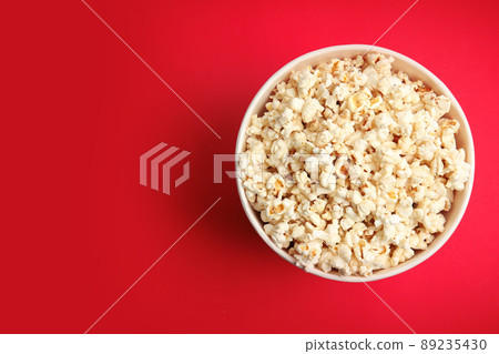 Tasty pop corn on red background, top view. Space for text Tasty pop corn on red background, top view. Space for text 89235430