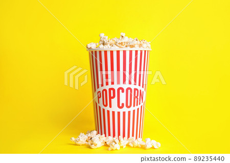 Tasty fresh pop corn on yellow background Tasty fresh pop corn on yellow background 89235440