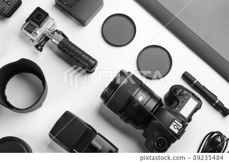 Composition with photographer's equipment and accessories on white background, top view 89235484