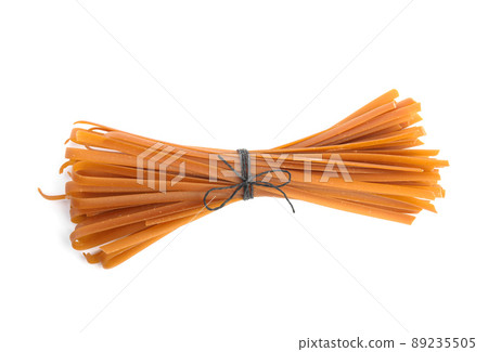Uncooked buckwheat noodles isolated on white, top view Uncooked buckwheat noodles isolated on white, top view 89235505