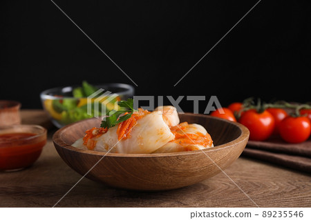 Delicious cabbage rolls served on wooden table against black background Delicious cabbage rolls served on wooden table against black background 89235546
