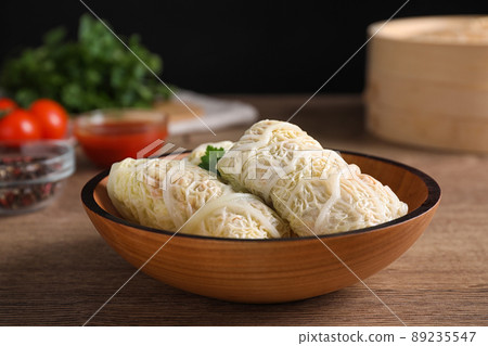 Delicious cabbage rolls on wooden table, closeup 89235547