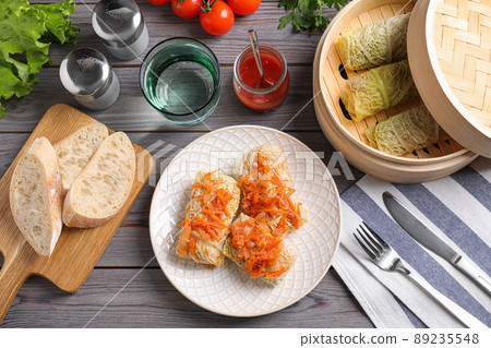 Delicious cabbage rolls served on wooden table, flat lay Delicious cabbage rolls served on wooden table, flat lay 89235548