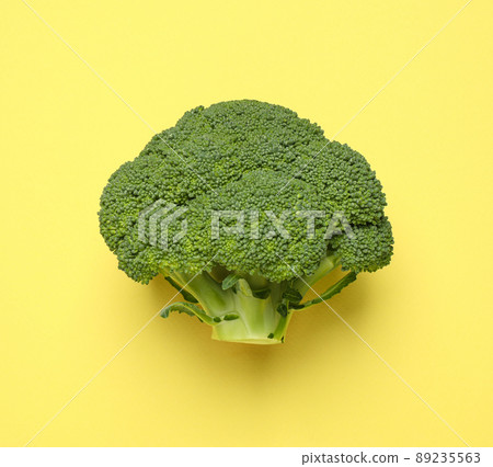 Fresh tasty broccoli on yellow background, top view Fresh tasty broccoli on yellow background, top view 89235563