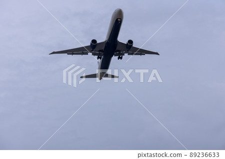 Jet plane seconds before landing on blue sky on a sunny day Jet plane seconds before landing on blue sky on a sunny day 89236633