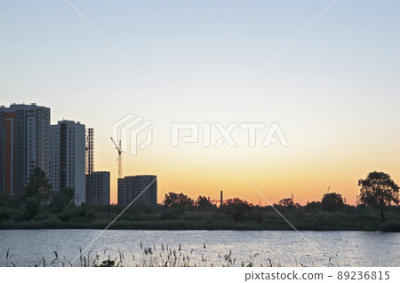 Sunset or sunrise in the city. Modern residential district near the pond of Saint Petersburg, Russia, Kupchino. 89236815