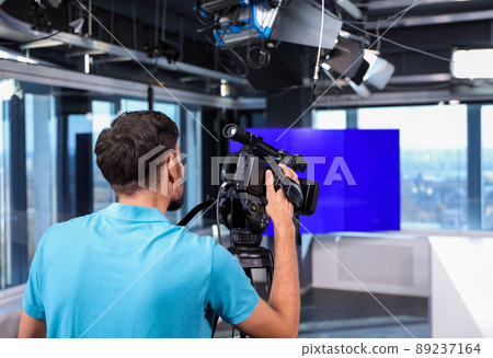 Professional video camera operator working in studio Professional video camera operator working in studio 89237164