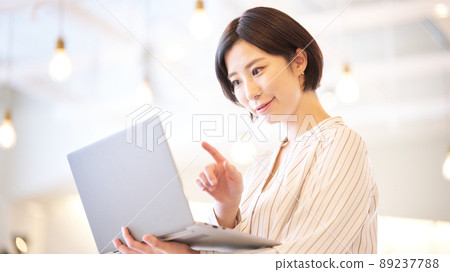 Young woman staring at the screen of a laptop 89237788