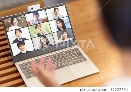 The screen of the PC making the video call and the image of the video conference online conference at hand 89237794