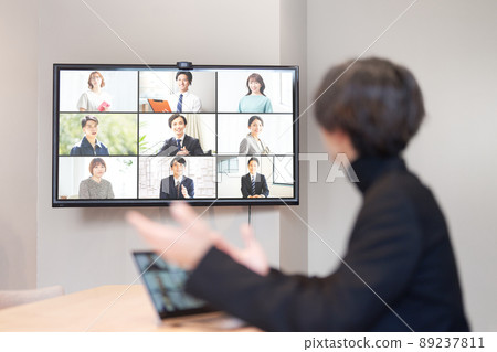 Rear view of a man making a video call Rear view of a man making a video call 89237811