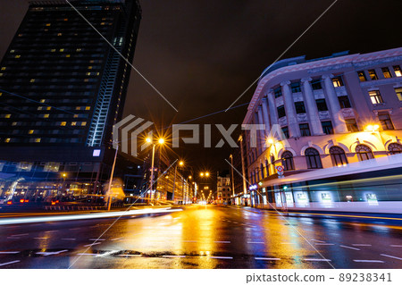 Long exposure of Riga main street Brivibas at night during rain in Latvia - Professional and best quality - Wet reflections on concrete with long car lights 89238341