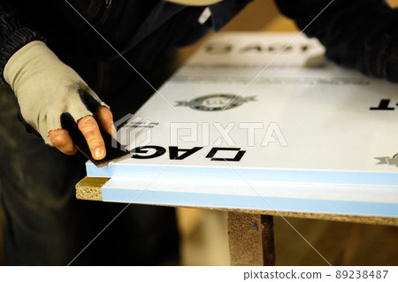 Woodwork and furniture making concept. A carpenter in the workshop doing joinery 89238487
