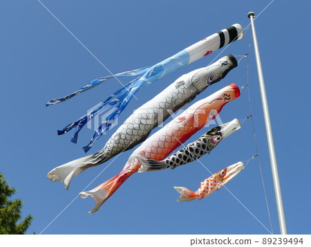 Carp streamer swimming in the blue sky Carp streamer swimming in the blue sky 89239494