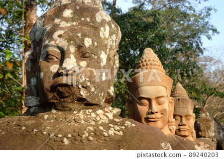 Ancient devas statues carved out of stones depicting the scene of Samudra Manthan (Devas Pulling Vasuki) at the gate of Angkor Thom, Siem Reap, Cambodia. Ancient devas statues carved out of stones depicting the scene of Samudra Manthan (Devas Pulling Vasuki) at the gate of Angkor Thom, Siem Reap, Cambodia. 89240203