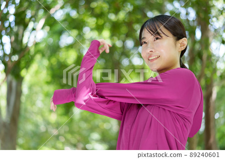 A woman stretching in the park A woman stretching in the park 89240601