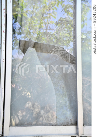 Broken windowpanes in a house 89243206