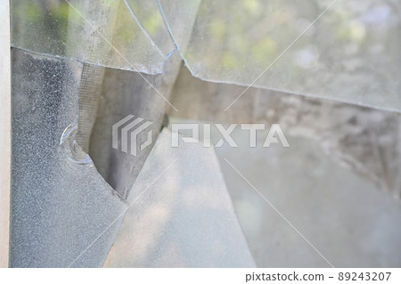 Broken windowpanes in a house 89243207