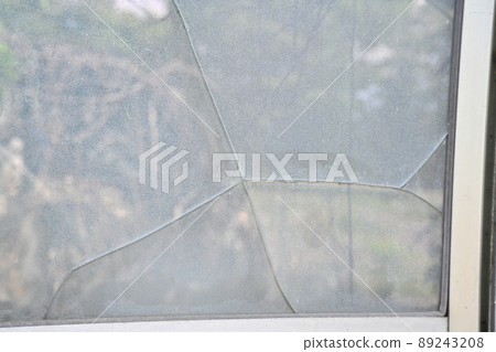 Broken windowpanes in a house Broken windowpanes in a house 89243208