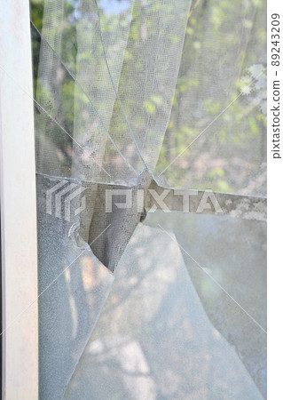 Broken windowpanes in a house Broken windowpanes in a house 89243209