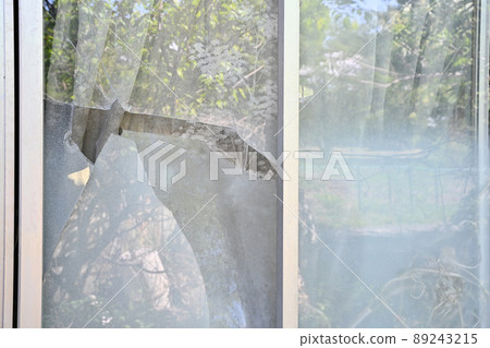 Broken windowpanes in a house 89243215
