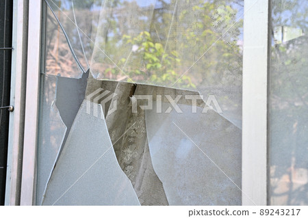 Broken windowpanes in a house 89243217