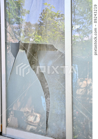Broken windowpanes in a house 89243219