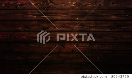 Horizontal background image of a black-brown board with wood grain and knots struck horizontally 89243739