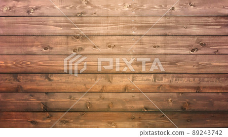 A horizontally long background image in which a yellow-brown board with wood grain and knots is struck horizontally. 89243742