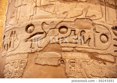 Different columns with hieroglyphs in Karnak temple. Karnak temple is the largest complex in ancient Egypt. Different columns with hieroglyphs in Karnak temple. Karnak temple is the largest complex in ancient Egypt. 89243891