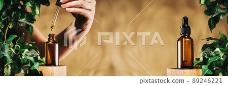 Natural medicine or aroma oil concept vial. hand with a dropper Natural medicine or aroma oil concept vial. hand with a dropper 89246221