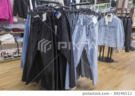 Green And Blue Men's Trousers On Hangers In Female Hands. Revision In The  Store. Stock Photo, Picture and Royalty Free Image. Image 44261782.