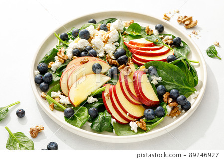 Apple and spinach fresh sweet fruit salad with blueberry, cheese cottage and walnuts Apple and spinach fresh sweet fruit salad with blueberry, cheese cottage and walnuts 89246927