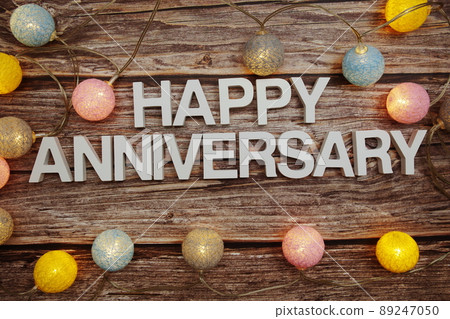 Happy Anniversary text with LED cotton balls decoration on wooden background Happy Anniversary text with LED cotton balls decoration on wooden background 89247050