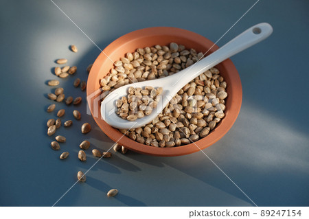 A bunch of cannabis seeds lie on a spoon and plate A bunch of cannabis seeds lie on a spoon and plate 89247154
