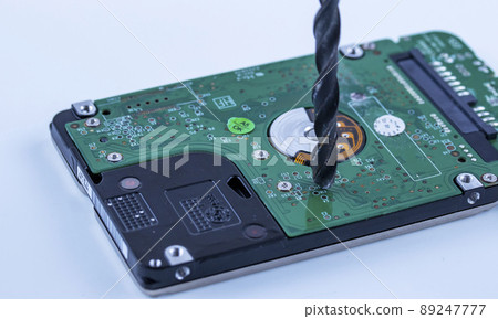 the hard drive from the computer is drilled with a large drill, macro 89247777