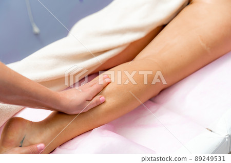 Facial massage. A woman is given a massage in a beauty salon. Close-up. 89249531