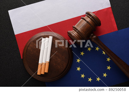 Cigarettes and Judge gavel on background of flag Poland and European Union. Illegal trade in cigarettes between Poland and the EU countries. 89250058