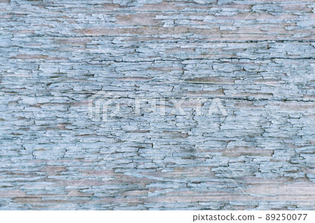 Wooden texture with scratches and cracks. A wooden wall with blue paint is heavily weathered and peeled. Wooden texture with scratches and cracks. A wooden wall with blue paint is heavily weathered and peeled. 89250077