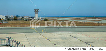 Control tower and runway in airport. Control tower and runway in airport. 89252367