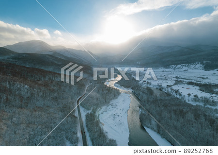Aerial view of Plateau Lago-Naki mountain twisted road in the winter and driving car. Epic, snowy white winter and snow capped forest. Aerial view of Plateau Lago-Naki mountain twisted road in the winter and driving car. Epic, snowy white winter and snow capped forest. 89252768