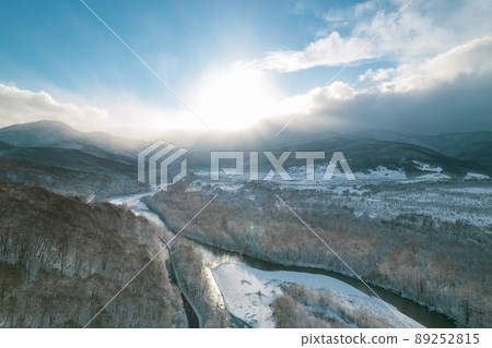 Aerial view of Plateau Lago-Naki mountain twisted road in the winter and driving car. Epic, snowy white winter and snow capped forest. Aerial view of Plateau Lago-Naki mountain twisted road in the winter and driving car. Epic, snowy white winter and snow capped forest. 89252815