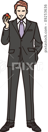 A man biting an apple whole body 89253636