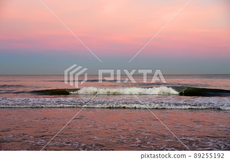 Waves at sea on dramatic sunset background. Waves at sea during storm and wind. Waves at sea on dramatic sunset background. Waves at sea during storm and wind. 89255192