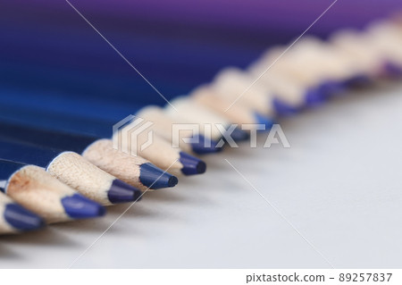 Set of blue identical pencils lie in raw 89257837