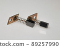 Carbon brush for electrical micromotor on white background. Macro image. 89257990