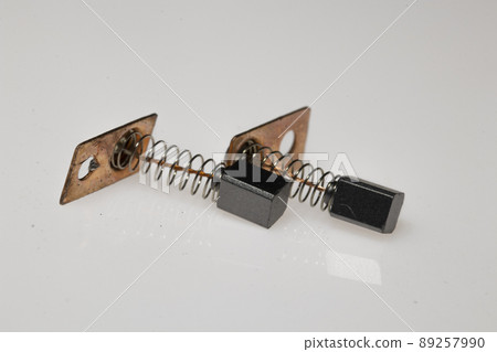 Carbon brush for electrical micromotor on white background. Macro image. Carbon brush for electrical micromotor on white background. Macro image. 89257990
